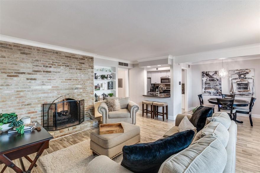 Welcome to this darling, rare GROUND LEVEL condominium located in the highly coveted Tuscany Condos! Kitchen with SS appliances opens to breakfast room and large living room with double sided, gas fireplace. Large primary bedroom with updated bath that boasts a shower bathtub combination. Tastefully updated and impeccably maintained, this home features laminate wood floors and tile flooring throughout (no carpet). TWO spacious outdoor areas perfect for pets and entertaining. One covered parking space just steps away from the front door. Ideally located near the community's tranquil fountain and resort-style pool. Numerous upgrades including 2020 HVAC, new refrigerator, new microwave, & fireplace gas log insert. Access to White Rock Lake & Katy Trail via Ridgewood Trail located behind the complex. PRIME Dallas location close to SMU, Downtown, and shops and restaurants!