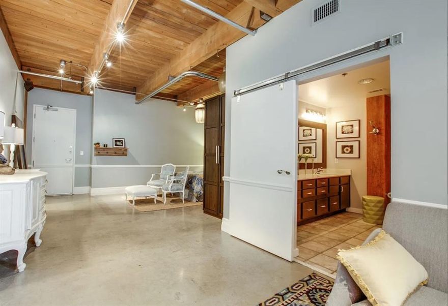 Welcome to Elm Place Residences—a unique residence in a historic saddle factory thoughtfully converted into loft-style units by a German developer in the 1990s. This home features an open floor plan with soaring high ceilings and concrete floors that highlight its industrial character. The kitchen is equipped with stainless steel appliances, and the unit includes a washer and dryer for added convenience. The bathroom offers both a separate shower and a soaking tub. Enjoy stunning views of downtown Dallas along with a direct view of the historic Grassy Knoll. A rare opportunity to own a piece of Dallas history in a truly distinctive building. You will want to come and see this one!