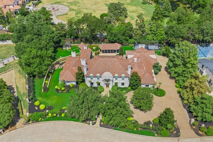 Stunning Mediterranean estate home minutes from all the shopping, dining, entertainment, and award-winning Carroll ISD that Southlake offers! Inside, you are greeted with a grand entry, striking formals, and a spacious great room where living, dining, and cooking combine to create the perfect entertainment space. The chef's kitchen boasts vast islands with seating, ample storage, high-end appliances, and a breakfast area. The library leads you to the serene primary suite with a sitting area, doors that open to the backyard retreat, and a spa-like ensuite with dual vanities, freestanding tub, walk-in shower, and expansive closets. Walk through the iron gates of the wine cellar hallway to the sprawling game room with a 20 ft bar, full kitchen, and more! Upstairs, a living room with a balcony and 4 well-appointed bedrooms with ensuites. Enjoy entertaining outdoors, swimming in the sparkling pool and spa, or playing on the sports court on these beautifully manicured private grounds.