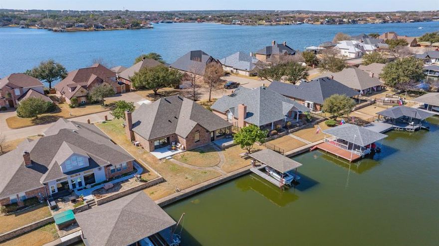 Your Lakefront Dream, Finally Within Reach.
Imagine waking each morning to the gentle shimmer of the lake just beyond your door — no projects, no repairs, no compromises. Just the peaceful, effortless lifestyle you've earned.
Welcome home to Waters Edge, one of Granbury's most coveted waterfront communities, where this fully and flawlessly renovated residence has been thoughtfully reimagined from the studs out. Every system is brand new — electrical, plumbing, and HVAC — so you can move in with absolute confidence and leave the worry behind for good. New windows flood every room with natural light while keeping the home whisper-quiet and energy efficient year-round.
Inside, the living room opens up beneath soaring vaulted ceilings, creating an airy, resort-like atmosphere that never grows old. A dramatic 12-foot sliding glass door frames your lake view like living artwork, then glides open to reveal a backyard that leads directly to the water's edge and your private boat dock. Whether it's a slow morning coffee as the mist rises off the lake, an afternoon out on the water, or a golden-hour gathering with family, this home was made for the moments that matter most.
With three generous bedrooms and two and a half bath — plus a private office that easily serves as a fourth — there's room to welcome the grandchildren, host the guests you've been promising a visit, or simply claim a quiet space of your own. And for those with vision, the attic offers nearly 900 square feet of untouched potential: a studio, a hobby room, a bonus suite — whatever this chapter of life calls for.
This is more than a home. It's the fresh start that feels like it was always waiting for you.