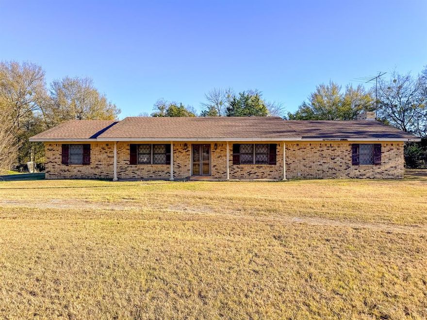 Discover the possibilities with this 4-bedroom, 2-bath home situated on 17.64 acres perfect for privacy, recreation, or agricultural. Located right outside peaceful Kerens, Texas, this property offers room to spread out and make it your own. Inside, you’ll find a spacious layout featuring a large living room with a wood-burning fireplace, a formal dining room with its own wood-burning stove, and a generously sized laundry room equipped with abundant shelving for storage. The bedroom off the front entrance is ideal for a home office, study, or guest room. All bedrooms include walk-in closets, and the main bathroom is equipped with a handicap-accessible tub. Step outside to enjoy the covered back patio, perfect for outdoor relaxation or shaded parking. The backyard includes an old pool house offering even more space for tools, equipment, or hobbies. This property is a true fixer-upper, ready for someone with vision to bring new life to its great bones and impressive acreage. With its combination of space, character, and potential, this Kerens gem is a rare opportunity you won’t want to miss!