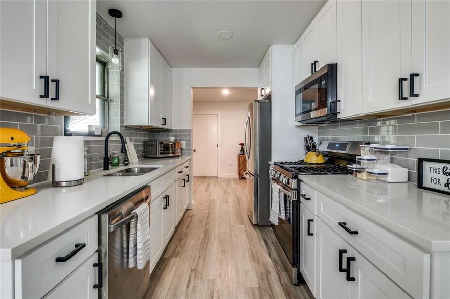 At 5921 Spring Glen Drive, the layout flows naturally from the living area into the kitchen and dining space, with updated flooring, clean finishes, and a balanced mix of modern touches and warmth that makes the home feel comfortable from the start. The living area is open and inviting without feeling oversized, while the kitchen delivers exactly what you need with white cabinetry, updated countertops, stainless steel appliances, and a layout that keeps everything functional and within reach. The dining area adds personality with a bold design element that brings life into the space and makes it feel unique.

Upstairs, the vaulted-ceiling flex space creates options—whether you need a home office, second living area, or a quiet retreat, it adapts easily. The primary suite offers privacy and a calm setting, paired with an updated bathroom featuring dual vanities and a clean, modern look. The additional bedrooms are well-sized and versatile, giving flexibility for guests, family, or work-from-home needs. Out back, the covered patio extends your living space outdoors, creating a spot to relax or gather, all within a fenced yard shaded by mature trees that give the space a more established feel. The seller is also selling washer and dryer along with the refrigerator!

Sitting on a 0.27-acre lot in a sought-after southern Dallas neighborhood known for its character and larger lots, this home also puts you in a convenient location with quick access to I-35E, making commuting simple. You are just minutes from the growing RedBird area with shopping and dining, along with nearby parks and The Golf Club of Dallas for outdoor time. The combination of updates, layout, and location makes this one easy to settle into without needing to change a thing. Schedule a showing to experience it for yourself