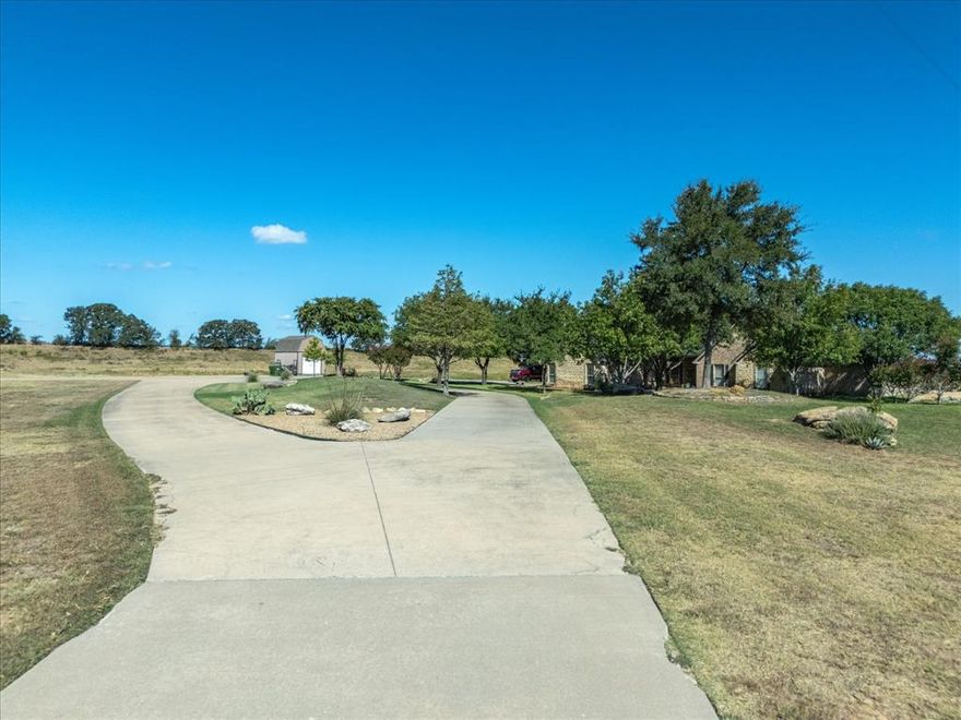 Don't judge a house by the highway road frontage.... you need to see this home!  Don't let the location fool you, this backyard is PEACEFUL!! Imagine zipping around on your motorcycles and ATVs, or just enjoying a peaceful evening while spotting deer, turkey or bird watching. The house offers a generous 3066 square feet of living space, freshly painted and cared for immaculately. Boasting two living rooms and an office that doubles as a sunroom. Floor to ceiling windows off the living area offer you a view that is unsurpassed! Whether you're throwing a grand backyard bash or enjoying a quiet evening, the back porch is your stage.  Worried about storage or tinkering space? Fear not. A workshop with electricity is ready for your projects, and there's a slab already laid down for an additional shop or guest home.