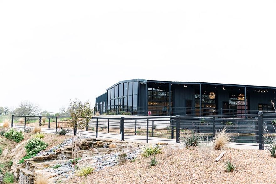 Beautiful modern venue sitting on acreage overlooking completely private 10 acre mini-lake. Great opportunity to jump right into business as it's already operable and has bookings into 2026. Sleek modern black exterior design separates this from any other venue in North Texas. Floor to Ceiling glass allows unmatched views of lake. Two completely separate units which also overlook water, current use is a Bridal suite and Groom Suite. Very fun and colorful interiors create an unmatched design unlike any other space. Built in 2023 so everything is completely new and beautifully designed. Large concrete bridge separates pond and lake with beautiful landscaped rock waterfall. Must see to understand how absolutely breathtaking this property is. Land also features a massive amount of road frontage on hwy 287. Also includes tons of acreage available to develop, build a house, cabins, motel, etc. Includes FF&E.