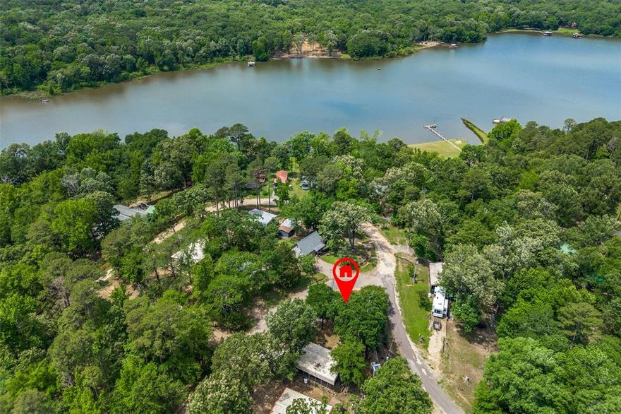 Tucked inside the gated lake-side community of Hidden Village at Lake Bob Sandlin, these two combined lots offer an ideal weekend getaway just two hours from Dallas. With water, septic, and both 110v&220v electric already in place, the site is ready for your RV setup or future build. A 30’ x 40’ awning provides covered parking for your trailer, complete with a separate stone parking pad designed for a boat or additional RV. The property also includes a storage shed with electric, ideal for tools or gear, and connections are in place to support outdoor lighting, TV, and more. Hidden Village is a private, planned retreat where you can ride ATVs or golf carts through secure roads and trails, reserve a large lakeside pavilion for gatherings, or fish straight from the lighted pier and boat dock sheltered from the open water. Additionally, the nearby Barefoot Bay Marina and RV Resort, located just a few miles away, offers 40 covered boat slips, a wide boat ramp, and the only dockside fuel on Lake Bob Sandlin, providing convenient access to the lake's recreational opportunities. Enjoy peaceful, low-maintenance outdoor living with community amenities designed for relaxation, recreation, and making the most of lake life.