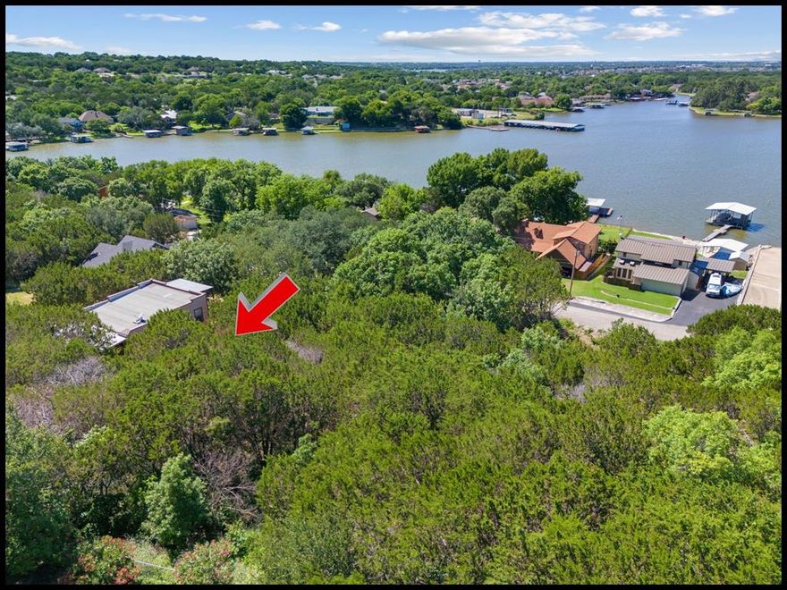Scenic Water View Lot in the Gated Lakeside Community of Indian Harbor – Over Quarter of an Acre.  Discover the perfect canvas for your dream home with this beautiful water view lot, offering just over a quarter of an acre of sloped, heavily treed land. Tucked away on the west side of Lake Granbury and just 12 miles from Glen Rose, this lot is ideally located off Highway 144—outside city limits but close to everything you need.  Set within the gated water front community of Indian Harbor, this property is surrounded by rolling hills and mature cedar trees, creating a serene, natural setting with the added charm of lakeside living. Enjoy the tranquility of country life just 10 minutes from the vibrant and historic Granbury Square, known for its boutique shopping, live music, entertainment, and top-rated dining.  Indian Harbor offers an array of amenities designed for comfort and convenience, including: gated entrance, Marina with boat launch and covered slips, Clubhouse with a sparkling community pool, Activity center and more.  Whether you're planning a peaceful weekend retreat or your forever home, this lot offers the perfect blend of privacy, beauty, and location. Embrace the lifestyle you’ve been dreaming of—right here in Indian Harbor.
