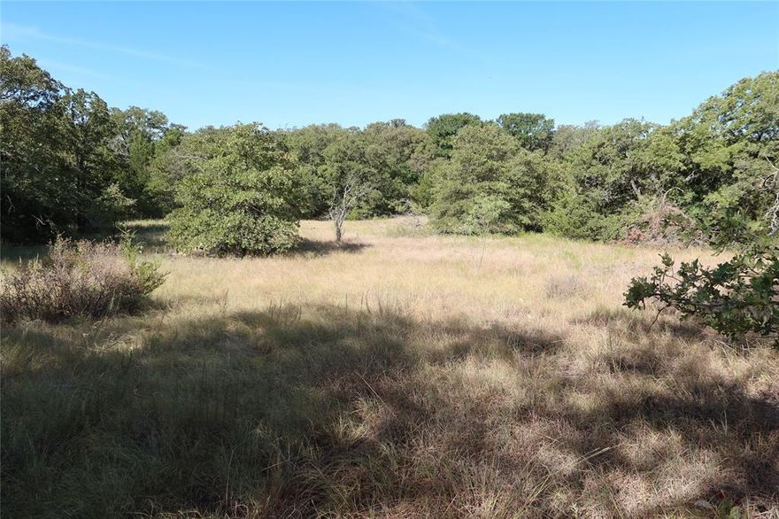 1.98 + - acres close to Amon G Carter Lake with road frontage on two sides .
