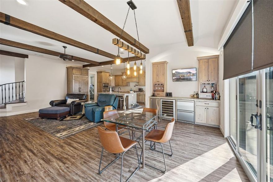 Live at the center of Dallas’ next great chapter in this custom-built residence in the heart of Trinity Groves. Positioned just minutes from Downtown, Uptown, the Design District, Bishop Arts, and the Margaret Hunt Hill Bridge, this home offers the rare combination of urban energy and private retreat in one of the city’s most dynamic growth corridors. Designed for those who value walkability and connection, you’re steps from chef-driven restaurants, art studios in the Tin District, and the future 250-acre Harold Simmons Park soon to feature riverfront trails, kayaking, pickleball courts, gardens, and an amphitheater. Few neighborhoods in Dallas offer this level of lifestyle accessibility with continued upside. Inside, the home blends warmth and sophistication with soaring ceilings, decorative wood beams, solid wood doors, custom iron stair railing, and luxury vinyl flooring throughout. The open-concept living space centers around a dramatic oversized island with gathered granite, GE Monogram appliances, built-in refrigerator, pot filler, and custom cabinetry ideal for hosting or everyday living. Upstairs, the primary suite is a private sanctuary featuring vaulted ceilings, a Juliet balcony with bridge views, dual walk-in closets, and a spa-inspired bath with cast iron soaking tub and expansive stone walk-in shower. Three additional bedrooms provide flexibility for guests, office, or fitness space. Outdoor living is equally impressive with an 8-ft cedar privacy fence set on a concrete footer, artificial turf with irrigation, stone patio with built-in griddle, and multiple sliding glass doors that create seamless indoor-outdoor flow. Energy encapsulation enhances efficiency and sound control, while tankless water heater and security system add modern comfort. For buyers seeking design, location, and long-term potential in one of Dallas’ fastest-evolving neighborhoods, this Trinity Groves opportunity delivers both lifestyle and value