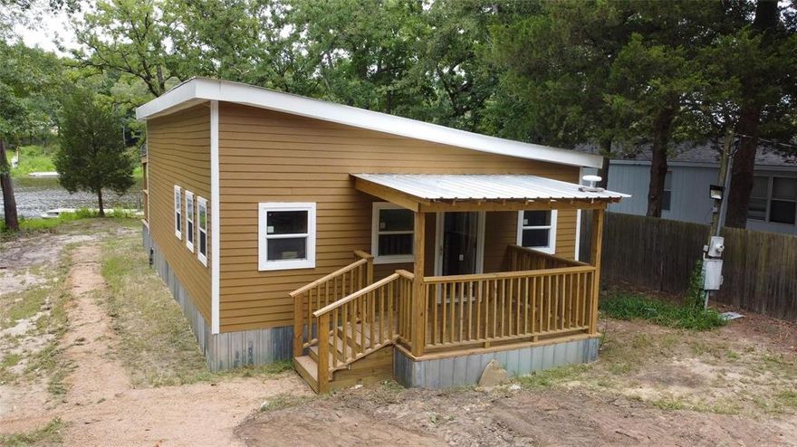 Fantastic Waterfront 920 sq. foot Lake Cabin with 2 bedrooms and 1 Bath located on 15 acre Hickory Hills Lake-Pond.  This lake only allows kayaks and canoes but the community has a large 365 acre spring fed lake called Callender Lake which you have full access to and allows all types of water craft.  This community has great boating, swimming, fishing, and other water activities.  This home has a front and back porch.  The back porch is very large and faces the water with a great view.  Interior of home makes you feel like you're living in a log home because the walls and floors are pine with cedar trim.  The dark cabinets in the kitchen and bathroom add a nice contrast of color to the home.  Home has split unit AC-Heat which keeps this home nice and comfortable year round.     Hickory Hills is a gated community with a boat ramp, fishing pier, community pool, lake swimming area, fishing pier, children's park, and so much more for your enjoyment.  Come see this one of a kind home today and start your LAKE LIFE.  Home is priced below the county appraisal tax value.
