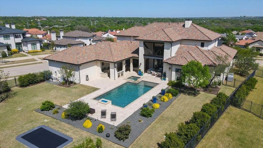 Welcome to this stunning home perfectly situated on a desirable corner lot in the guarded, gated La Cantera. Custom built by Integrity Homes, this home is an entertainer's dream. The living room is truly magnificent with floor to ceiling windows providing natural light and beautiful views of the backyard oasis. Beyond the living you will find a chefs kitchen featuring a large center island, top of the line SS appliances, butler's pantry with wine fridge, and two dining areas. The spacious master suite has a sitting area, separate vanities and an incredible walk-in closet. Downstairs you will also find a guest bedroom with an en suite bath and an additional room that could be used as either an office or 5th bedroom. Upstairs you will find two more large bedrooms with en suite baths. Continuing on there is a wet bar with a game room that any family would love! The large backyard features a sparkling pool, spa and fire pit. There are two covered entertaining areas in the backyard, one featuring a sitting area with a fireplace and the other a built-in grill and bar for eating. Don't miss the in-ground trampoline or the rare four car garage with epoxy flooring! This home truly checks every box- luxury, functionality, and incredible outdoor living!