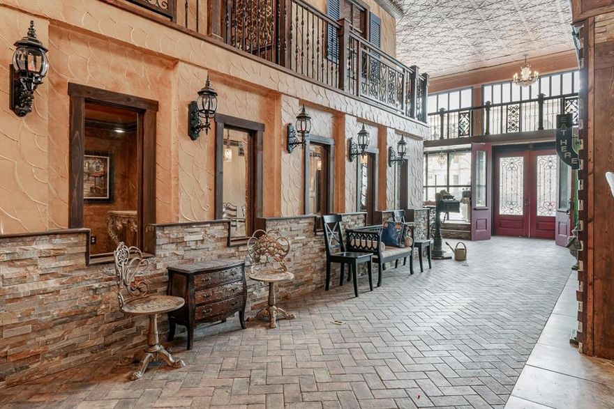 Step into a sophisticated masterpiece, where this extraordinary commercial property transports you to the charming streets of Venice. Every detail is designed to evoke the romance of European bistros, boutique storefronts, and intimate dining experiences.
Upon entering, you’re greeted by the ambiance of a quaint bakery, bistro, and coffee shop, beautifully framed by built-in cabinets and boutique window displays. Also, a grand cascading staircase draws you upstairs to an exquisite space designed for dining and entertaining. Atop these elegant storefronts, stylish dining areas provide the perfect setting for a romantic evening meal or gather together at the bar area which features a spectacular wine cellar. Step out onto the terrace and enjoy the open-air charm that completes this one-of-a-kind property. The main floor features multiple office spaces or showcase rooms, ideal for various business ventures. At the back, a fully equipped commercial kitchen and a laundry room offer convenience and functionality. This building is more than a commercial space—it’s an experience. Whether you envision a high-end restaurant, boutique venue, or a multi-functional event space, this property is ready to bring your vision to life. Don't miss this rare opportunity to own a landmark in the heart of Haskell!