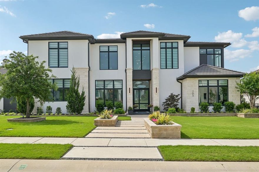 In the gated Crescent Heights community of Southlake and award winning Carroll ISD, this exceptional modern custom estate offers upscale living  minutes from Southlake amenities. Positioned on a .64 acre interior culdesac lot within walking distance to Bicentennial Park and The Marq Southlake. This home captures beautiful Texas sunset views and offers 7,328 square feet of thoughtfully designed living space. A striking stucco and stone exterior with custom iron and glass entry opens to soaring ceilings, custom floors, designer lighting and a dramatic wood & stone fireplace anchoring the main living area. Open concept design blends modern architecture with refined finishes for elevated everyday living. The main level features the luxurious primary suite with spa inspired bath, freestanding tub, dual entry custom shower and separate walk in closets with direct utility room access. Two guest bedrooms, one serving as exercise room, also on 1st floor. Chef’s kitchen includes Wolf appliances, a six burner gas cooktop with commercial vent, Sub Zero refrigeration, custom cabinetry, peninsula island & quartzite waterfall countertops, along with a full secondary catering kitchen, stainless appliances and private entry. First floor also includes a private media room, expansive game room, two dedicated offices with BI cabinetry, and four car garage access. Smart home automation and foam encapsulated insulation enhance comfort and efficiency throughout. Upstairs offers an open family room loft with built in snack bar and sweeping views of the living space below, three spacious ensuite bedrooms including one mini master suite, an additional living area, laundry room & bonus 420sf of unfinished mini primary suite. Resort style backyard features a covered patio, overlooking the pool, spa & fireplace lounge, outdoor kitchen with gas grill and dining area. Southlake living at its finest where timeless style, exceptional craftsmanship and vibrant community lifestyle come together.
