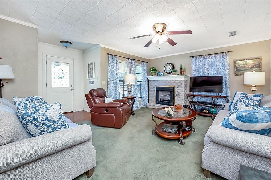 Motivated Seller!!  Your home for the holidays!  Warm and welcoming living room with gas log fire place greets you as you enter this meticulously kept home.  The remodeled eat in kitchen, with custom cabinetry, stainless dishwasher, built in gas range oven and microwave is open to the living room.  The renovated bathroom separates the two bedrooms and has beautiful wainscoting, built in vanity with granite counter.  A large walk-in closet is conveniently located in the hallway between the primary bedroom and utility room.  The utility room is large enough for a full size washer and dryer,  an extra freezer,  has built in cabinets, storage closet and a back entry door that leads to a large concrete patio that is shaded by a large oak tree.  The fenced in back yard has plenty of room to garden or play and has a large storage shed.  The carport is large enough for two cars and also has a storage closet.  Hurry and come see this property so you don't miss out!