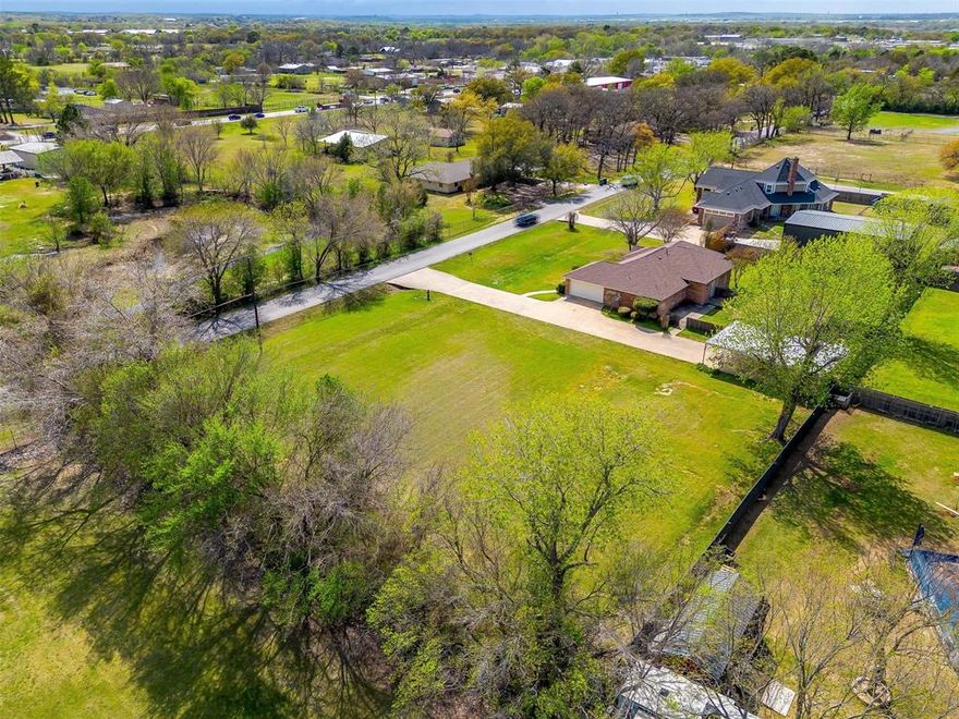 NEW ROOF!  A rare find in Burleson! This versatile property sits on a spacious one-acre lot and offers incredible potential. The home features oversized bedrooms, including a front room that can serve as an office or second living area. The inviting living room boasts abundant natural light and a cozy fireplace, while the kitchen provides ample cabinet and counter space. A separate utility room adds convenience. The property includes both an attached garage and a detached 20x40 garage, which presents endless possibilities—it could be transformed into a future mother-in-law suite, workshop, or additional storage. With a total of eight covered parking spaces, including a carport, your vehicles will be well protected, especially during unpredictable spring weather. The expansive backyard is shaded by mature trees, perfect for relaxation or entertaining. Plus, the extra lot offers the opportunity to build another home or explore commercial potential. Conveniently located off Rendon Road, near shopping and I-35, this property is a must-see! NO HOA!
