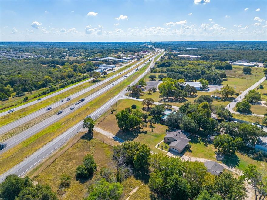 Prime Commercial location with 4 acres On I-35 with Road Frontage on the service road.  Located right past Hidden Creek Parkway going South.  Currently zoned Commercial with endless possibilities for your commercial business. Presently the property has a 2,088 SF house with 3 offices, 2 bathrooms, reception and a kitchen with attached 2 car garage perfect for office spaces AND a separate 400 SF Office building with 4 separate spaces. See attached information from The City of Burleson with requirements. Half of the acreage is undeveloped and a blank slate for your plans and ideas. High traffic area in burleson and this site offers excellent visibility and accessibility, making it ideal for a commercial business.