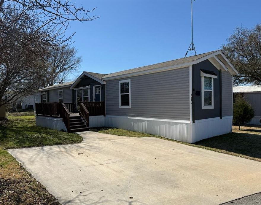 Move-in ready and well-maintained 2021 manufactured home offering 1,216 sq ft with 3 bedrooms and 2 bathrooms located in the Southfork-Denton community in north Denton.

The open-concept living area flows into a modern kitchen featuring stainless steel appliances (refrigerator less than one year old with ice maker, oven, and dishwasher), a touch-free vent hood with remote, and a large center island with plenty of prep space and seating. A Wi-Fi-enabled programmable smart thermostat helps reduce heating and cooling costs.

Interior upgrades include a sliding barn door with modern hardware, rain shower heads with handheld wands in both bathrooms, and a thermostat-controlled floor vent fan booster in the second bedroom for faster heating and cooling. Additional features include central HVAC, keyless front door entry, Ring doorbell, washer and dryer hookups, and a large deck for outdoor relaxation.

Financing may be available through manufactured home lenders, making ownership possible for many buyers who may not qualify for traditional home loans.

Manufactured home only - land not included. Buyer must obtain park approval. Current lot rent approximately $800 per month.