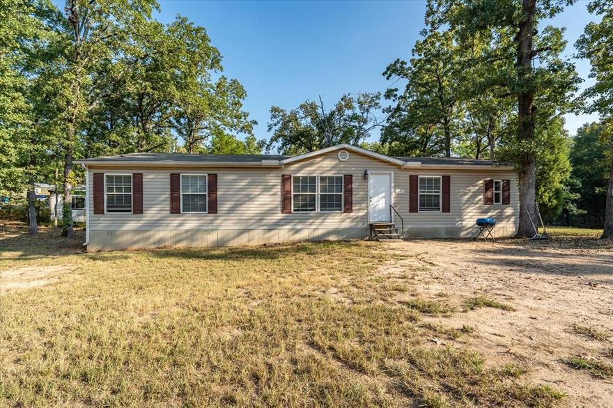 Lake days are calling! This 4-bedroom, 3-bath manufactured home in Log Cabin, TX sits on a shady corner lot with mature trees. Inside, the open split floor plan features a spacious kitchen with abundant storage, a private primary suite with oversized bath and laundry access, plus three additional bedrooms and two full baths—perfect for family or guests. Just minutes from boat ramps, boat and jet ski rentals, and endless water fun! This home offers the ideal blend of comfort, convenience, and East Texas adventure. Schedule your showing today!