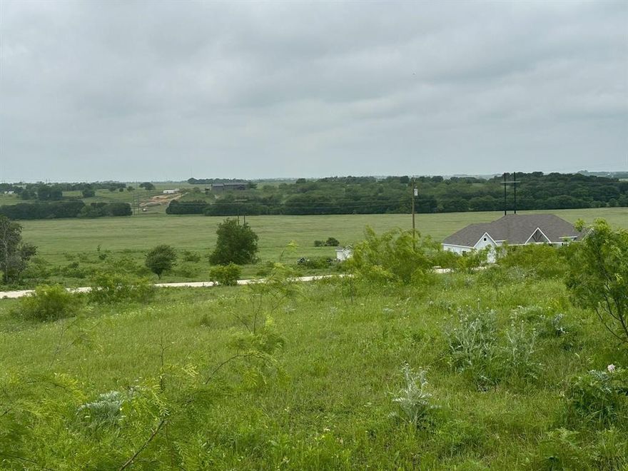 10.52 acres in Grand View Ranch with the kind of elevated setting that is hard to ignore. Lot 77 sits atop one of the higher points in the development, offering scenic long-range views and a strong homesite presence that helps separate it from other available tracts in the area.
This property is well-suited for a custom home, barndominium, or private getaway for someone who wants to enjoy open space, privacy, and a slower pace without giving up access to Fort Worth and Dallas. With only one home currently built on the street, the setting still feels quiet and lightly developed, adding to the appeal for buyers looking to step away from the city proper.
Grand View Ranch continues to attract buyers looking for acreage, scenery, and flexibility in a ranch-style community. Located about 49 minutes from Fort Worth and 60 minutes from Dallas, Lot 77 offers a rare balance of peaceful country living and practical convenience. If views, space, and privacy matter, this property is worth serious consideration.