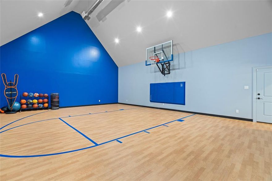 This stunning traditional, custom-built, one-story Texas estate perfectly blends classic charm with high-end luxury! Situated on 5.62 beautiful gated acres, outside city limits and close to the new Sanger High School- this timeless property with gorgeous main residence featuring an INDOOR BASKETBALL COURT, a large 3 bedroom, 1200 sf guest house and enormous 3600 sf shop that rivals any sports bar with video wall and fully equipped saloon- offers space, privacy and exceptional lifestyle features for both relaxation and entertaining! Upon entering the main residence, you will immediately fall in love! The gorgeous entryway welcomes you into the dining and formal living rooms while the open floor plan is ideal for entertaining in both the living room and chef's dream of a kitchen. Natural light pours in through the wall of windows in the front and back of the living areas flowing seamlessly into the backyard paradise! The spacious primary bedroom with spa-like primary bathroom and closet with custom built-ins, connecting to the laundry room for efficiency and ease- is separated from the 3 secondary bedrooms, each with large walk-in closets, full bath and a jack-n-jill bath, giving the utmost privacy. The entire home boasts beautiful flooring throughout and unique custom upgrades that elevate every room- from designer light fixtures, custom built-ins in the kitchen, laundry room, every walk-in closet and office to the beautifully crafted stone fireplace and everything in between! The luxury continues outside in your private paradise- a massive resort-style pool with slide, grotto and cascading waterfall and full outdoor kitchen including a smoker, pizza oven and grill are the perfect backdrop for spending your time enjoying the gorgeous Texas evenings overlooking the large stocked pond with several seating areas, a gorgeous waterwall feature, chipping mats and multiple fireplaces, you'll never want to leave! All of this plus LOW taxes with a wildlife exemption!