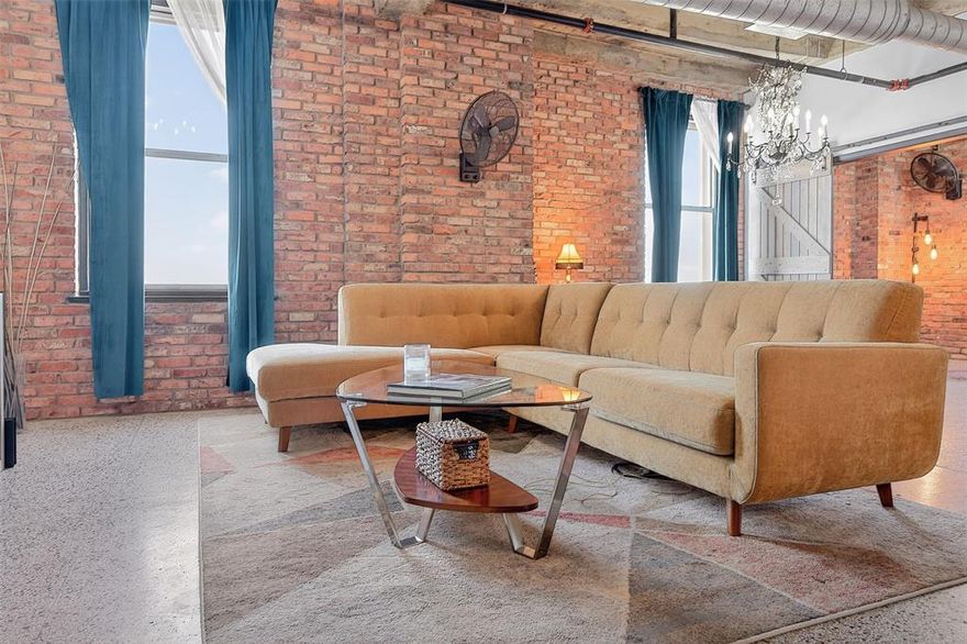 Prime corner unit at the historic Texas & Pacific Lofts. 9th floor condo has panoramic views of bustling South Main Village and sunset views over the cultural district to the west. The stunning interior features bricked walls, custom light fixtures, and a chef's dream kitchen with granite counters, premium KitchenAid appliances, and wine refrigerator. One of the largest units in the community with plenty of storage space, including 2 walk-in closets. Large capacity LG stacked washer & dryer. 

Iconic 1931 Art Deco building has stunning architectural features, terrazzo floors and lots of amenities: 24 hour full service professional concierge, landscaped courtyards with propane grills, fitness center, resistance pool, owner's lounge, media room. Enjoy the new Station & Vine restaurant and wine bar downstairs, opening May 2026.

TexRail to DFW Terminal B departs from this building 7 days a week. Walk to Sundance Square, Near Southside, Magnolia Ave, or take the commuter train to Dallas or Grapevine for dinner. Hop on the free downtown trolley to Sundance Square directly in front of the building. Run, bike, or kayak along the nearby Trinity Trails.