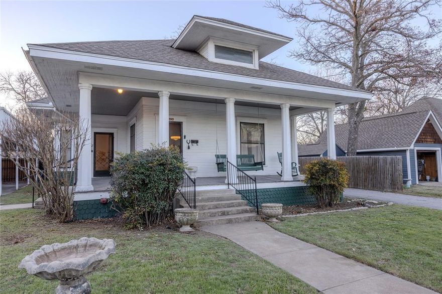 Step back in time with this charming, early 1900's home located in the historical Couts district just blocks from the Courthouse Square. This house still boasts its original hardwood floors, a formal dining room with a stained-glass windows and glass-paned double doors adjoining the roomy parlor. A glorious wraparound wood veranda with comfy porch swing will beg you to just sit and relax with a cup of tea and a good book. Very well maintained with major updates to attic insulation, electrical, gas, foundation, and new central HVAC, all in 2017. New 12 x 24 workshop with electric added to back of Carriage House, also in 2017. In 2020, complete bathroom remodel including plumbing, tile flooring, bathtub and sink; tankless water heater installed; new roof and privacy fence; both bedrooms remodeled; utility room added; and new electric range in kitchen. Original Carriage House in back with loft has had electrical updates; two carports; beautiful front and backyard. Timeless perfection!