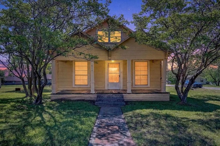 Full of charm and unique character, 800 S Jefferson in Pilot Point offers a rare combination of flexible living space, mature trees, and an oversized double lot on a corner lot. Built in 1963, this one-and-a-half-story home has a warm, inviting feel with features that make it truly one of a kind and offers the perfect opportunity to add your own updates and personal style over time.
One of the most memorable details is the pull-out staircase leading to a loft area, creating a fun and versatile bonus space perfect for a kids’ playroom, home office, reading nook, craft room, or additional flex space. It’s the kind of feature buyers remember and immediately start imagining ways to make it their own.
The double lot provides exceptional outdoor space with huge mature trees offering shade and a beautiful natural setting. In the spring, the front yard comes alive with blooming bluebonnets, creating a stunning seasonal display that adds to the home’s charm and small-town Texas feel. Whether you envision gardening, room for pets and play, future expansion, or simply enjoying the extra elbow room, the lot size opens the door to endless possibilities.

A 2-car garage adds valuable storage and parking, while the corner lot layout gives the property a spacious feel with added accessibility.

This home is ideal for buyers who appreciate character over cookie-cutter, with vintage charm, flexible space, and plenty of potential to polish and make uniquely their own. Conveniently located in Pilot Point near schools, downtown dining, shopping, and local amenities, it offers small-town living with room to spread out.

If you’ve been searching for a home with personality, space, and the opportunity to create something special, this property is a must-see.
