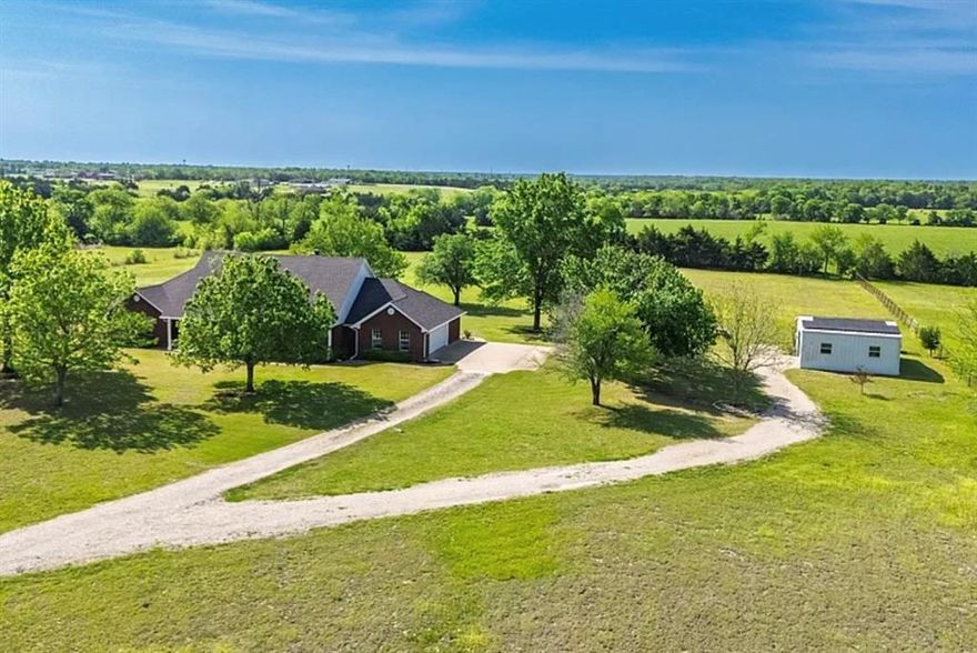 RARE 7.5+ ACRE PRIVATE RETREAT IN CADDO MILLS ISD. Escape the city to this solid brick custom home featuring a massive 30x24 (720sf) WORKSHOP with electric—perfect for hobbies or business. The 3-bed, 3-bath floorplan is anchored by a spacious 20x18 living room with a wood-burning fireplace and a renovated kitchen. ENERGY EFFICIENT: 2023 Solar Panels installed to crush summer electric bills. NO HOA means you bring your boat, RV, and livestock. Enjoy true privacy with a private pond and mature trees, just minutes from Hwy 36. Caddo Mills schools + Acreage + Workshop = The complete package. See it today.
