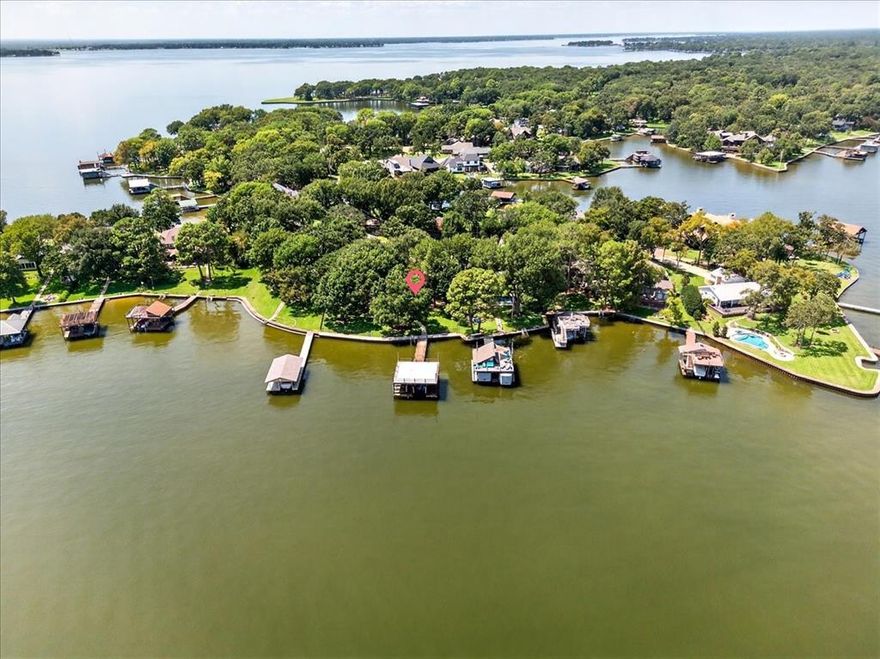 First Time on the Market, Waterfront Home in Deer Island Estates, Cedar Creek Lake!  This four bedroom, four full bathrooms plus a guest half bath, 3,287 sq ft waterfront home is available in one of Cedar Creek Lake’s most desirable communities. Built as a second home and meticulously maintained by its original owners, the property offers a rare combination of function and lakefront living.  Each bedroom includes a private ensuite bath for maximum comfort and privacy.  Open concept kitchen, abundant counter space, and a large island, opening to the family and dining areas for seamless entertaining, all with wonderful open water views.  A screened-in back porch extends the living space, providing year-round enjoyment of lake views and surrounding nature. Situated on two landscaped lots totaling over half an acre, the property is shaded by mature oaks and enjoys eastern-facing lake views.  The spacious boathouse has a boat slip, or up to four PWCs, offering easy access to the water.  Ideal as a full-time residence or vacation retreat, this home’s location, condition, and water access make it a rare opportunity on Cedar Creek Lake.  Come see our new floors throughout!   Beautiful hardwoods!  Check out the new garage floors also!
