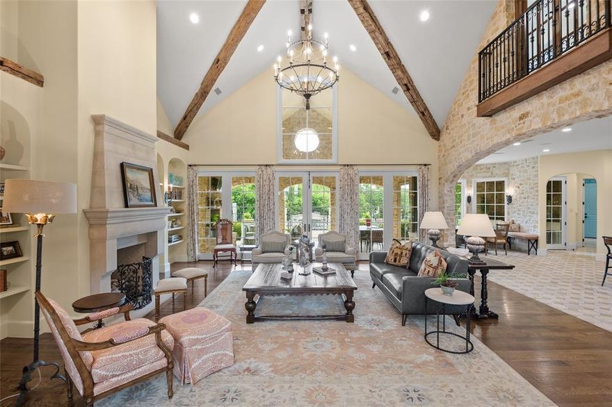 This gorgeous Italian Villa, designed by the renowned Richard Drummond Davis and featured on the cover of Texas Living, is secluded on 18 acres that perfectly blends timeless elegance with modern luxury, bringing the benchmark of Mediterranean style right to the heart of Ellis County! Highlighted by a dramatic entryway, the prominent front turret houses the statement staircase. The foyer opens directly into the expansive family room, dominated by a vaulted ceiling with antique roughhewn wooden beams salvaged from a local barn.  The same rough-faced limestone used on the exterior also define the entry & archways in the living and kitchen.  Entertain effortlessly with a chef's kitchen to die for flowing effortlessly into several dining spaces and living room including both a walk-in pantry and separate butler's pantry.  The primary wing features light gleaming in from windows on 3 sides, a fireplace, French doors providing access to the pool, backyard, covered outdoor kitchen and dining areas.  Few properties can match the design and functionality of the primary bath and 2 primary closets.  Each bedroom has its own ensuite bath AND there's Texas' most relaxing massage room.  Upstairs you'll find the office, guest quarters and the massive media room.  Step outside to your personal oasis; a sparling pool with a one-of-a-kind slide, separate spa, enormous, covered patio with a 3rd fireplace and outdoor kitchen built for hosting unforgettable gatherings 12 months a year.  It doesn't stop there with a detached barn offering extensive storage and versatility easily accommodating 4 more vehicles PLUS your boat, RV and ATV.  This is more than a home- it's private estate where luxury, space and lifestyle come together in perfect harmony.