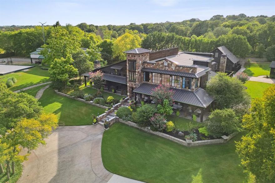 Experience unparalleled luxury and exclusivity with this remarkable estate in Argyle, set on a sprawling 6+ acre lot that offers endless opportunities for living, entertaining and income potential. The completely renovated 7,474 sq. ft. main home is a masterpiece of modern design, featuring vaulted ceilings, rich hardwood floors, exposed wood beams and expansive windows that flood the space with natural light. The heart of the home is a chef-inspired kitchen w-top-of-the-line SS apps, built in fridge, a spacious island, butler’s pantry, and a cozy hearth room with a stone fireplace. The private primary suite is a true retreat, showcasing a spa-like bath w-a glass-enclosed shower, freestanding tub, dual vanities and a custom walk-in closet. Entertainment options abound, with a whiskey room behind elegant stained-glass doors and a one-of-a-kind game room with a floor-to-ceiling fireplace, indoor spa, vaulted ceilings and backyard access, where there is ample space to add a future pool. The estate extends far beyond the main residence, offering a 2-bedroom, 1,075 sq. ft. guest house, a 360 sq. ft. cottage apartment and an air-conditioned garage. Outdoor amenities include a barn with three stalls, a tack room, and insulated storage, as well as a sand volleyball court, sports court & extensive lush landscaping with mature trees and a serene pond. The property’s screened and covered patios provide additional spaces to relax and enjoy the tranquil surroundings. Whether you’re seeking a family-friendly estate, a luxury VRBO with no restrictions, a wedding venue, or a private retreat, this property offers limitless possibilities. There’s even a fully equipped office space inside the main home that could be leased for additional revenue. The location is ideal and the gated private driveway ensures both privacy and security. This exclusive estate is truly unlike anything else on the market, don’t miss this rare opportunity to own a property that stands in a class of its own.