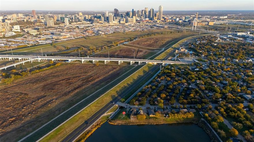 An oversized 9,078 square foot residential lot is available in the ever-changing West Dallas area. This land is able to have single-family or duplex construction, providing unobstructed views to Downtown Dallas. This corner lot is positioned next to bodies of water, guaranteeing no neighbor to the rear and North-facing sides. Areas of interest include Trinity Groves and the Design District that are each only a few minutes away. An upcoming development by the City of Dallas called Harold Simmons Park is also in the works nearby.
Whether a substantial-sized home or an income-producing duplex is developed, don’t be the one that regrets not taking advantage on this opportunity. 
Please ask for the property website - Survey and concept Site Plan is available. The site plan is intended to show how a duplex build can be set on the land - where the main facade faces the levee and downtown Dallas. 
Seller is motivated and can provide concessions for the Buyer!