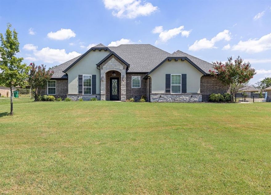 Motivated sellers! Captivating 4 bedroom PLUS an office on a .54 acre fenced lot in gated community of De Cordova Ranch. Soaring vaulted ceilings, natural light from the wall of windows and a centrally located stone hearth LP fireplace make this living room the heart of the home and a perfect place to entertain. The kitchen features gas cooking, undermount lighting, spacious island with bookcase end, generous pantry, coffee bar area with tons of storage and stainless steel appliances. Owners suite is a spacious retreat with tray ceiling with up lighting, ceiling fan, views to the backyard and a spectacular ensuite bath with double vanities-one with seating area, separate walk in shower, jetted tub and ENORMOUS closet with built in mirror and shelving. Secondary bedroom at front of home in office hallway with bath and 2 other split bedrooms on other side of the home with full bath. Separate laundry room with hanging area or room for 2nd fridge, and cabinets. Footlocker area makes keeping things tidy a breeze. Outside features include a covered patio, pipe fenced backyard and irrigated lawn with plenty of room for a pool!. 2 water heaters new as of Nov 2024 and AC condenser is new this year. Epoxy floor in garage. Community Center featuring open landscaped park, equipped playground area, picnic tables and outdoor grills, covered pavilion with bathrooms and kitchen.