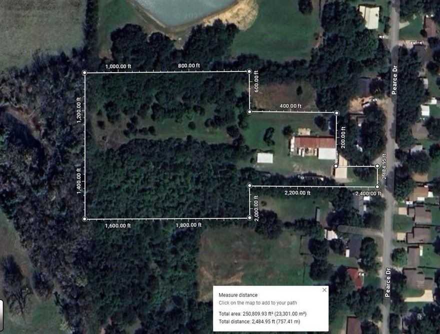 This offering includes approximately 5.75 acres out of a total 6.27-acre parcel, with multiple outbuildings. The two residences and approximately 0.5 acres will not be included in the sale.

The back roughly 5.75 acres offer ample space for constructing a large custom home or pursuing development opportunities.

Property is being sold for the land but there are existing structures.  All structures are being sold as is. Improvements include a 10-bay garage with cement flooring and electrical, capable of accommodating up to 14 vehicles, as well as a separate two-bay RV carport. An old laundromat building is also located on the property. 

Please note: All boundary lines and measurements are approximate. A new survey will be required to separate the two residences and the excluded roughly .5 acre portion of land.