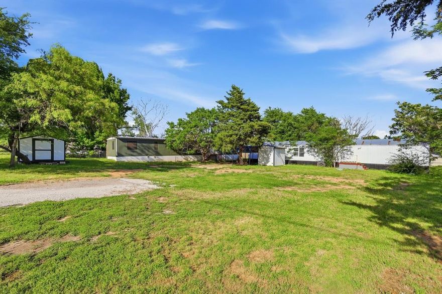 Located on a 1-acre corner lot in  Springtown, TX, this property sits outside city limits and offers a range of possibilities. With two mobile homes already on site, it’s well-suited for those looking to generate income, accommodate multiple living arrangements, or explore future development options.

The generous lot size provides plenty of room for parking, outdoor projects, or additional improvements. Existing utilities add convenience for those considering updates or new construction. Whether you’re planning to renovate, replace, or build a new home, this property offers the space and flexibility to bring your vision to life.

A great opportunity to own land with multiple potential uses in a more open, less restricted setting, while still being within a reasonable distance to local amenities. Selling AS IS!