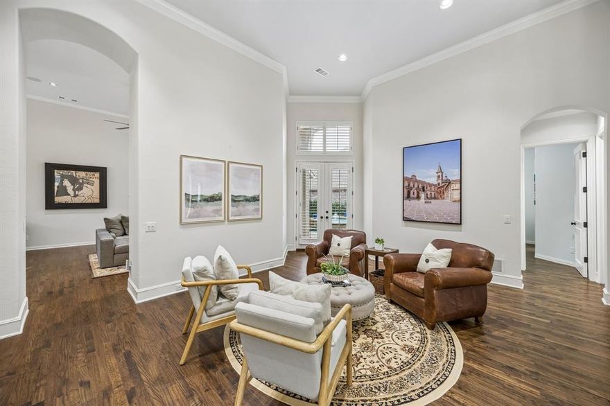Refined Mayfair Custom home in the Village of Ballantrae — an intimate enclave within the master-planned community of Stonebridge Ranch and just moments from The Dye Golf Club at The Clubs of Stonebridge Ranch. Designed for discerning buyers who appreciate quality construction and thoughtful upgrades, this single-story residence offers solid oak flooring throughout most of the home, 8-foot solid wood doors, plantation shutters, and generous ceiling heights. The kitchen is both sophisticated and functional with stainless steel appliances, double ovens, gas cooktop, granite surfaces, abundant cabinetry, and a butler’s pantry with wine storage. Extensive improvements over time include a 40-year HD roof, upgraded drainage and gutter systems, solar attic fans, LED lighting, updated bathrooms and hardware, replaced windows, enhanced sprinkler system, dual water heaters with leak detection, and refreshed cabinetry and built-ins. The three-car garage is climate-controlled with epoxy flooring and insulated doors — ideal for a collector, hobbyist, or fitness space. The private backyard retreat features a raised spa, plunge pool, and covered patio, with updated pool equipment for ease of ownership. Additionally, it is beautifully landscaped with Japanese yews, junipers, and natural stone accents, creating a peaceful and low-maintenance outdoor retreat perfect for relaxing or entertaining.