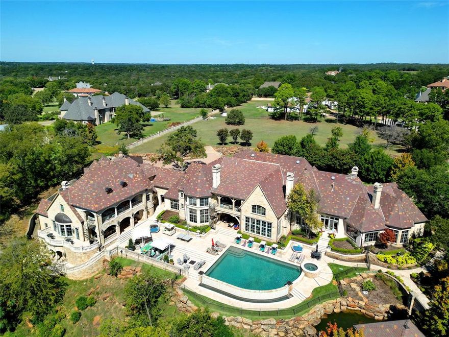 LOCATED IN CHATEAU DU LAC, GATED & GUARDED NEIGHBORHOOD, WITHIN WALKING DISTANCE TO LAKE GRAPEVINE*WATERFRONT COMMUNITY*4.22 ESTATE ACRES WITH MATURE MAJESTIC TREES*ADDITIONAL 2 LAND PARCELS CAN BE ADDED BACK TO PRICE OR SOLD SEPARATELY for 8 total acres*GATED AT PROPERTY SITE*AMENITIES INCLUDE 3 ACRE POND WITH FOUNTAIN, WATER WHEEL, KOI POND, INFINITY POOL-SPA, PIZZA OVEN CANOPY WITH FIREPLACE & OUTDOOR LIVING AREA*LUSH LANDSCAPING & GARDENS, MANAGED BY GROUNDS KEEPER*STONE BALLISTERS AT VERANDAS & BALCONIES OVERLOOKING POND & FOUNTAIN*10 CAR COVERED PARKING*6 CUSTOM FIREPLACES*6 LIVING AREAS, 6 BEDROOMS, 9 TOTAL BATHS*WINE CELLAR & TASTING ROOM WITH KITCHENETTE*SELECT SLATE ROOF*2 KITCHENS*MAIN HOUSE PLUS GUEST HOUSE TOTAL FOOTAGE OF 14,906 PER APPRAISER SKETCH*BUILT 2008*HAND SCRAPED HARDWOODS  & TRAVERTINE THROUGHOUT*NATURAL GAS LINES*SECURITY SYSTEM*ENTRY BOAST FLOATING STAIRCASE, DOME CEILING WITH COVE LIGHTING, DOUBLE IRON FRONT DOOR & GRAND CHANDELIER*FORMAL LIVING, FORMAL DINING*PRIVATE PRIMARY ENSUITE LOCATED TO THE LEFT OF ENTRY, INCLUDES OFFICE AND 2 SITTING AREAS*FABULOUS FAMILY ROOM OPEN TO BREAKFAST & KITCHEN- GREAT VIEWS OF POOL, FOUNTAIN & WATER WHEEL*KITCHEN FEATURES MONOGRAM APPLIANCES-BUILT IN REFRIGERATOR, 2 OVENS, 6 BURNER COOKTOP*ABUNDANT CUSTOM CABINETRY WITH ISLAND, COFFEE BAR AREA, CURVED STONE PLANNING CENTER WITH BUILT IN DESK*GRAND LIBRARY WITH SPIRAL STAIRCASE*GUEST BEDROOM ON IST LEVEL AS WELL AS PRIMARY ENSUITE*GUEST HOUSE ADDITION FEATURES *GREAT HALL”, A 2ND FULL KITCHEN, MASSAGE-SPA ROOM, MEDIA.STUDY, GAMING ROOM. ADDITIONAL BEDROOMS* 
TWO SPILLWAYS HELP WITH DRAINAGE FOR PROPERTY*AEROBIC SEPTIC SYSTEM*SEE NTREIS DOC FOR MORE INFO ON DRAINAGE & SPILLWAYS*IRRIGATION  CONTROLLED BY DEEP WELL & POND*PUMP HOUSE ON SITE*
SEE AMENITIES SHEET ON NTREIS DOCUMENTS*DRONE VIDEO & 360* WILL SELL ADDITIONAL 2 PARCELS*CALL FOR PRICING, PARCEL R240094 IS 2.013 ACRES & PARCEL R2040097 IS 2.103 ACRES*THIS LISTING ONLY INCLUDES 4.223 ACRES