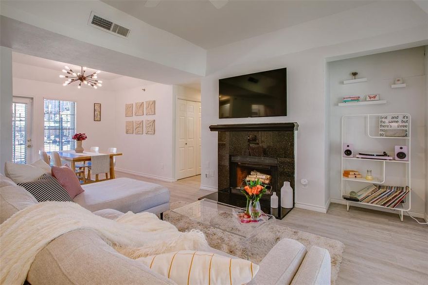 Sought after first floor 2-2 in the Bryan Place condos. Fall in love with the recently renovated kitchen featuring custom cabinets, quartz counters, and a timeless subway tile backsplash. The living and dining areas are highlighted by a wood burning granite fireplace, high tray ceilings, 2 private patios for outdoor enjoyment and LVP flooring leads you throughout the home. The bedrooms are split in layout, each with access to one of the patios. The primary has a large ensuite bath featuring granite counters, large vanity, tub-shower combo and an oversized walk-in closet. The guest bedroom also has an expanded walk-in closet and shares the renovated hall bath with granite counters. Additional highlights to this beautiful condo include tons of natural light, covered-assigned parking and access to the Bryan Place Community Pool, all blocks to downtown Dallas and the Arts District.