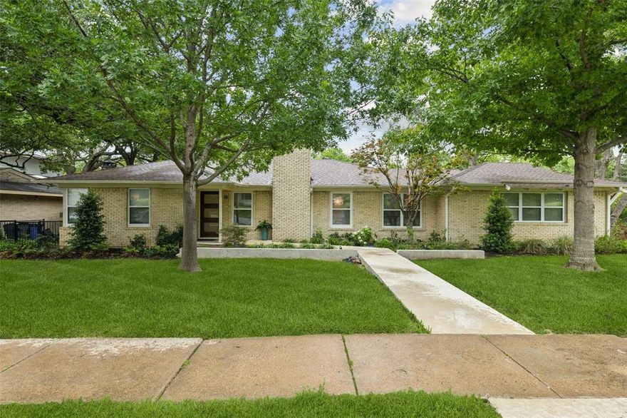 Perfectly positioned along the peaceful shoreline of Yosemite Lake and zoned to highly sought-after Lakewood Elementary, this beautifully updated ranch sits on an oversized, tree-shaded lot in a charming pocket of urban Dallas. Blending timeless character with modern comfort, the home offers an open, inviting layout ideal for both everyday living and entertaining. The formal living room makes a striking first impression with custom built-ins and a dramatic gas fireplace, creating a warm and welcoming gathering space. Just beyond, the spacious kitchen and adjoining den overlook the lush backyard and feature abundant cabinetry, a center island, gas range, granite countertops, stainless steel appliances, and distinctive slate flooring. The casual den seamlessly connects to a bright second living area lined with a wall of windows that flood the home with natural light. The private primary suite features rich wood flooring and a spa-inspired bath complete with a soaking tub, separate walk-in shower, and dual vanities. A secondary bedroom is served by a beautifully updated hall bath. Additional highlights include a two-car attached garage, updated windows, generous storage throughout, and a large outdoor deck perfect for relaxing or entertaining under the trees. Enjoy an unbeatable location just minutes from the restaurants, shopping, and daily conveniences of Hillside Village, along with close proximity to White Rock Lake’s scenic trails, parks, and outdoor recreation. This rare lakeside setting offers tranquility, charm, and convenience in one exceptional property.