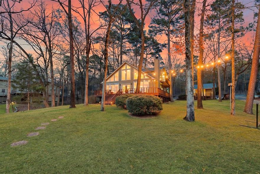 Fantastic home in Twin Coves Subdivision on Lake Cypress Springs. Perfectly positioned on a beautiful lot at the cusp of a quiet cove, the property offers stunning main lake views and a serene waterfront setting. Step inside to find a bright, open floor plan with floor-to-ceiling windows that frame the gorgeous lake views. The spacious living area features a charming rustic rock fireplace and French doors that lead out to an oversized patio, ideal for relaxing or entertaining. The kitchen is beautifully updated with granite countertops, stainless steel appliances, and a large island that offers ample space for cooking and gathering. The primary suite is conveniently located on the main level and includes an en-suite bathroom with modern finishes. A second oversized guest room with its own full bath is also located on the main floor. Upstairs, you'll find a secondary living area, two additional bedrooms, and a full bath—perfect for guests or family. The outdoor space is a true highlight, with a detached garage, generous patio areas, and a one-stall boathouse just steps from the home. An additional interior lot is included. This property is being sold mostly furnished, making it an exceptional opportunity to step into lake living with ease. A rare and fantastic deal on a beautiful waterfront lot!