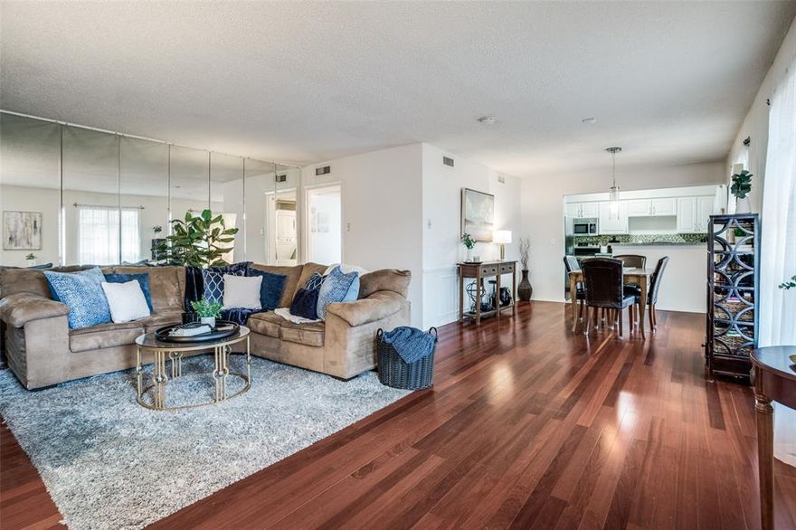 Beautiful well-maintained garden-style condo in the hidden gem of La Fontaine. Inside the gates, underneath a canopy of trees, you'll find a quiet, peaceful setting with landscaped gardens and fountains. This 2nd floor condo is a corner unit with excellent natural light! Open, spacious floorplan has rich hardwood flooring in living and dining, with plush, upgraded carpet in bedrooms, newly replaced Feb 2026. Both Bedrooms have attached full baths. Spacious closets and good storage space throughout! Kitchen has a french-inspired color palette, white cabinets, SS appliances and good-sized pantry! Washer and Dryer in Unit. Assigned Covered Parking Spot is Close to Entry Gate, Reserved Spot #65. Generous amount of guest parking available. Private Community Pool is one building over between 6017 and 6015. Lock and Leave Lifestyle in the heart of Dallas, walking distance to Central Market, Ridgewood Trail. Convenient access to Greenville Ave, SMU, Northpark!