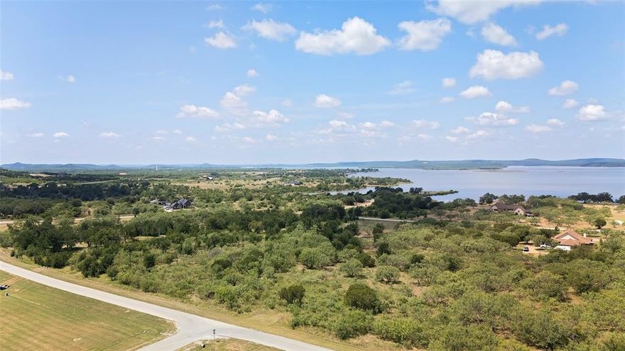 This stunning one+ acre lot in The Hills Above Possum Kingdom is the ideal canvas for your dream home. With ample space for a custom-built residence, lush landscaping, and the privacy you desire, this property is truly a rare find. Imagine waking up each day to the breathtaking beauty of your surroundings.

Just a stone's throw away, the community's clubhouse features a fitness center and a stunning infinity pool, offering panoramic views of the lake—this serves as the perfect backdrop for relaxation and socializing. The clubhouse also includes workout facilities and community rooms, providing a vibrant space for residents to connect and stay active.  
As a property owner, you'll enjoy access to an array of exclusive amenities, including Ritchie Cabin, which features a picnic area perfect for outdoor dining and gatherings with family and friends, as well as a convenient boat launch.

Nestled in a picturesque setting on the northern end of the lake, this community boasts rolling hills and endless opportunities for outdoor activities, from hiking to wildlife viewing. Behind the gates, you'll find a peaceful and exclusive living environment, ideal for escaping the hustle and bustle of city life.

Just 15 minutes from town, you can enjoy the best of both worlds: the tranquility of nature and the convenience of urban amenities. Experience PK Lake Life at its finest in this amenity-rich community designed for relaxation and enjoyment. Don’t miss your chance to claim your slice of paradise!