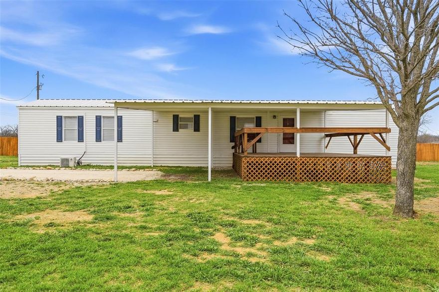 Cutie pie and country living all wrapped into one! This charming 2-bedroom, 2-bath single-wide mobile home sits on a spacious .89-acre fully fenced corner lot, offering room to roam, garden, or simply enjoy the peace and quiet.

Step up to the oversized 20x15 covered front porch... the perfect spot for morning coffee, evening sunsets, or gathering with friends and family. Inside, the home has been recently refreshed with brand new carpet and fresh paint, giving it a clean, bright feel that’s truly move-in ready.

The thoughtful layout includes two full bathrooms, providing comfort and convenience for everyone. With nearly an acre of land, a corner lot location, and updates already done, this property offers the perfect blend of cozy living and outdoor space.

Affordable, adorable, and ready for its next owner to love - come take a look!