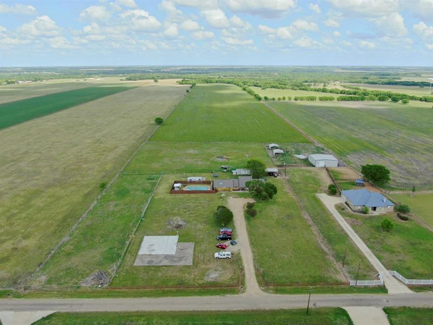 Experience the beauty of true country living in the charming town of Italy, between Dallas and Fort Worth. This inviting property offers the ideal blend of peaceful rural lifestyle and convenient access to city amenities, making it a rare opportunity to enjoy the best of both worlds. Set on just over 4 beautifully maintained acres, this property is fenced and cross-fenced, ready to accommodate your animals and country lifestyle dreams. Whether you envision horses grazing, chickens roaming, or space for goats and cattle, this property delivers the flexibility and functionality to make it all possible. A small workshop with electricity adds even more versatility—perfect for storage, or weekend projects. Featuring four bedrooms and three full bathrooms, there is room for everyone to spread out and feel at home. The oversized primary suite is a true retreat, offering abundant space and a very generously sized ensuite bathroom designed for relaxation. Just off the primary bedroom, you’ll find a cozy adjoining office space—ideal for working from home or nursery. A secondary bedroom with its own full bath creates the perfect setup for a guest suite or multi-generational living, providing both privacy and convenience. Recent updates including a new roof, siding, and fresh exterior paint enhance both the curb appeal and peace of mind for years to come. Step outside and discover your own private oasis—an inviting in-ground pool awaits, offering the perfect escape during those warm Texas summers. A true highlight of this property is the covered back porch, where you can unwind and take in the serene views of your land and the surrounding properties, each offering similarly generous acreage that enhances the sense of space and privacy. If you’ve been searching for a place where you can slow down, spread out, and embrace the charm of small-town living while still staying connected to major city hubs, this is your opportunity to own your own slice of Texas paradise.