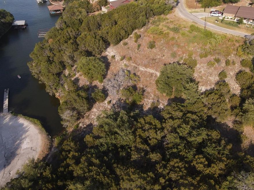 Deed and community HOA information can be emailed, survey available.  This lot is very sloped, but would make a great walk out basement or stick built home with a nice deck overlooking the lake, 3 additional lost available priced individually or as a package, (not included in this price) 2607, 2609, 2611 to provide more road frontage for less expensive build job, the land to the east has also been cleared and you can see the difference in the brush, this property doesn't face the lake but backs to the community boat dock.  Email agent for additional information.