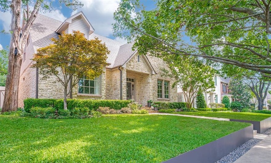 Beautifully situated on a tree-lined block just steps from boutiques and restaurants of historic Snider Plaza, this stunning home blends elevated lifestyle, attention to detail and thoughtful design in an exceptional University Park location with access to HPISD schools. The close proximity to SMU campus means that art, athletics, and theater are right around the corner. Built to exacting standards by The Oliver Group and extensively remodeled by renowned Maestri Studio, this one-owner home offers a smartly curated footprint that welcomes sophisticated living and effortless entertaining. Every element of this pristine residence exudes quality. The center hall design with classic wainscoting opens to a light-filled library complete with oak paneling and bookcases, coffered ceiling and a built-in ladder that rolls to reach favorite volumes. Inlaid, red oak hardwood floors flow throughout the elegant living and dining spaces that are ready for gatherings. The chef’s kitchen includes granite counters, a large island, Thermador cooktop, KitchenAid appliances, custom cabinetry, and butler’s pantry for additional storage. The breakfast room opens to a comfortable family room that features a beadboard ceiling and is designed around a hand cut, Austin limestone fireplace. An ensuite bedroom, home office and half bath complete the downstairs. A second stairway leads to a huge bonus room that can transform into a hybrid workspace, game room and more. The primary suite features a vaulted ceiling, sitting area and walk-in closet with custom cabinetry. The ensuite bath is a true spa retreat with custom Glassworks shower stall, Kohler Bubble Massage tub, Dornbracht waterfall faucet and Bardiglio marble counters atop floating dual vanities. Two spacious bedrooms with ensuite baths and a laundry room with custom cabinetry complete the second floor. Outside, beautiful landscaping and spacious covered flagstone patio create the perfect place to enjoy an alfresco dinner with friends.