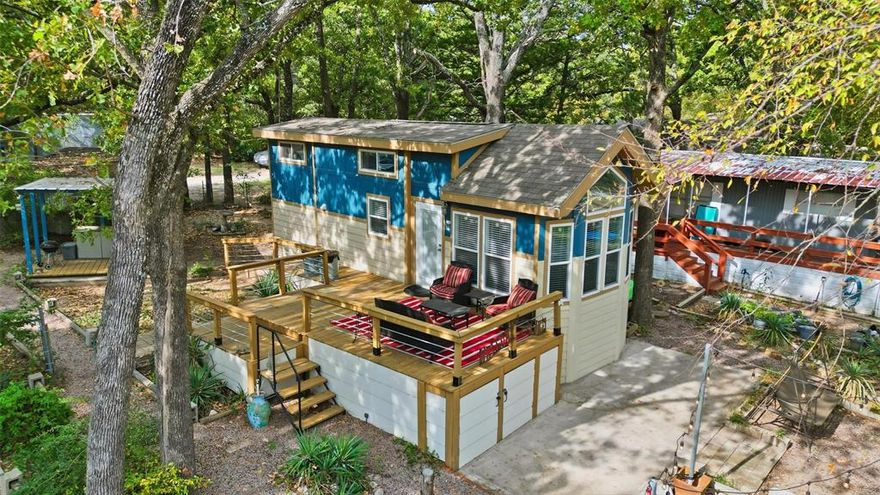 **UNIQUE PROPERTY** CASH ONLY. LAKEFRONT with WATER VIEWS on LAKE TEXOMA! Approximately 600 sq ft tiny home featuring a modern design with professional skirting and decking. *Fully furnished* and ready to enjoy! Interior offers a king-sized bedroom, loft with 4 twin beds, and a pull-out couch. Large deck overlooking the lake. Includes full-size appliances, washer and dryer hookups, two heat and AC units, and a full bathroom with standard-size shower. Tiny Home is set on the previous home’s concrete foundation and secured with professional hurricane ties. Located in Cedar Point Club, a gated community of 25 residences in Gordonville’s Sherwood Shores. Enjoy lake views, docks, fishing pier, and diving platform. Club membership required. No rentals or short-term stays allowed. Recreational use only—no full-time residency permitted. HOA dues: $600 per year, covering septic access (grandfathered lateral lines), internet, electric, water, and boat slip. Two storage units behind the home included. Seller is also willing to sell boat on a separate bill of sale.