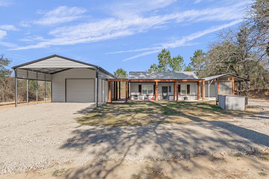 Charming, move-in ready remodeled cottage on a half-acre with dream shop and tons of extras in desirable Cross Roads ISD. No deed restrictions, and no water bill thanks to well water and a water softener. This very well-maintained home features an open floor plan with nine-foot ceilings, Country French kitchen, and a breezeway with rustic knotty pine ceiling connecting the house to an incredible 720-square-foot shop. The stylish kitchen offers elevated counters, granite breakfast bar, European style cabinets with three lazy Susans to make the best use of space, stainless steel range, microwave, dishwasher, shiplap accents, and a trendy tile backsplash that runs to the ceiling. The primary bedroom has access to the 1 bath with updated tiled shower, and laundry space. The 730 SF shop is a true man’s dream, with tongue-and-groove cedar knotty wood walls, 220-volt power, LED lighting, and plugs all the way around. The pavilion shaped cover on the front of the shop is tall enough for equipment, tall trucks or cars. Home has a metal roof, gutters, French drains, outdoor lighting, and a lifetime composite deck for easy outdoor living and enjoying the lovely view. An extra carport with storage provide abundant covered parking and storage, plus an outdoor shower adds a fun, practical touch. The front of the home has a large front porch for sitting and enjoying the outdoors. Recently updated 2025 exterior paint. This well-maintained home is move in ready and in the desirable Crossroads School District.