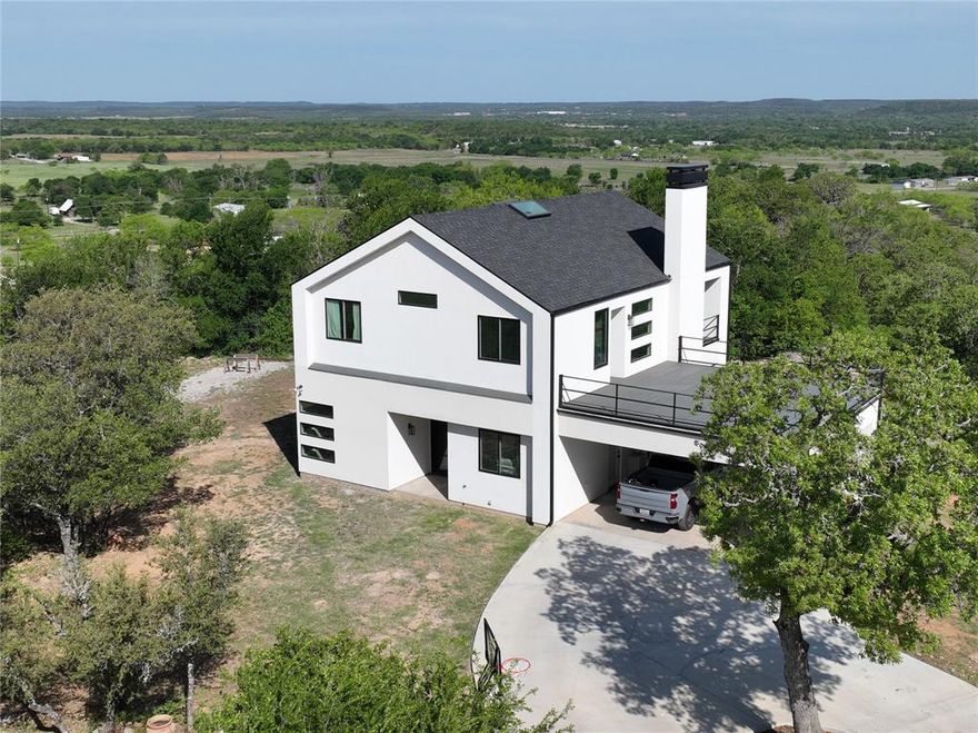 Picturesque all around views!!! This 2144 sq. ft. contemporary modern home sitting on 5.2 acres on Hog Mountain is a gem! The stucco exterior with a mix of metal and wood gives this house a perfect blend. The two story, 3 bedroom 2 and half bath house, sits about 600 feet off a cul-de-sac giving it a peaceful setting to enjoy the views, trees, large rock clusters and wildlife. The amazing views are a sight to see, especially relaxing on the balconies. Inside features of the house include decorative lighting, large skylight opening, floating stairs, kitchen island, open kitchen shelves, unique window designs, a fireplace, dual vanities in the full bathrooms and a garden tub. The large windows and skylights give an abundance of natural light in the house. The attic and exterior walls have spray foam insulation for energy efficiency. Don't miss out on this one!
