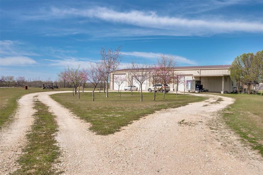 If you like lots of elbow room and a huge workshop, this property is for you! Barndominiums are very popular and this one is set on 10 sprawling acres just about 5 minutes north of charming downtown Krum. You're also less than 10 minutes from Denton with all the shopping, medical care, churches, schools and great restaurants. With 3600 square feet in the workshop side of the barndominium, there is room for EVERYTHING! This side has an RV hookup, is fully wired and completely insulated. The doors are rated to withstand up to 90 m.p.h. winds. Upstairs there is an open loft, a huge storage room that is 920 sq.ft. and another room that is often used as a bedroom. 
In the living area, the spacious kitchen flows into the family room that has lots of natural light. The master bedroom features a large walk in closet that is accessible from the second bedroom and the 3rd room is used as an office. There is plenty of insulation between the floors to reduce noise as an added feature. Now let's go outside and explore this wonderful property. There are fruit trees in abundance- peach, pear, apricot and pecan so you can enjoy the bounty from those and share with friends.You'll see 5 water storage tanks holding 3,000 gallons each; and the well is over 500 ft.deep. Exterior, night-friendly lights (pointed downward) surround the building and there are outlets in all the eaves as well. In addition, 7 of the 10 acres are ag exempt so your taxes are extremely low. This property has so many features that you really just have to see it, so go ahead and make that appointment to get it before somebody else does!