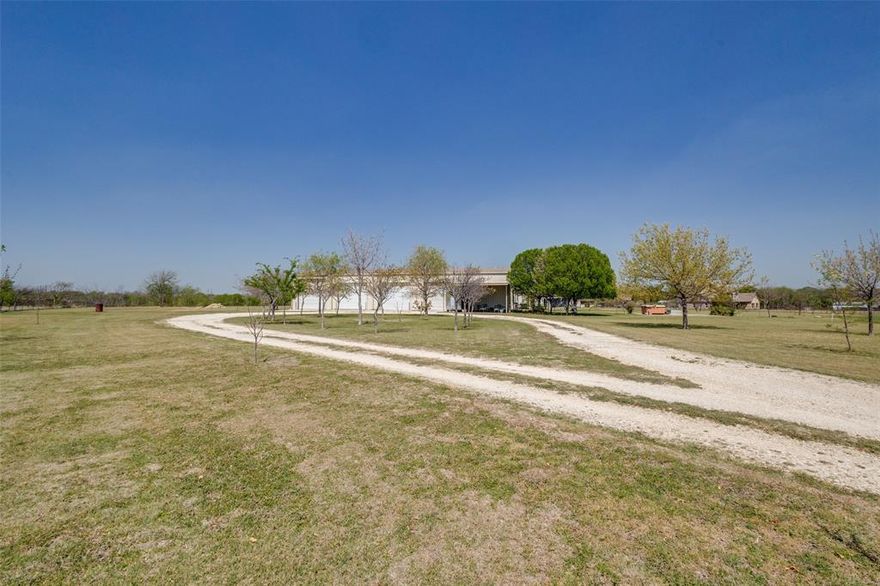 If you like lots of elbow room and a huge workshop, this property is for you! Barndominiums are very popular and this one is set on 10 sprawling acres just about 5 minutes north of charming downtown Krum. You're also less than 10 minutes from Denton with all the shopping, medical care, churches, schools and great restaurants. With 3600 square feet in the workshop side of the barndominium, there is room for EVERYTHING! This side has an RV hookup, is fully wired and completely insulated. The doors are rated to withstand up to 90 m.p.h. winds. Upstairs there is an open loft, a huge storage room that is 920 sq.ft. and another room that is often used as a bedroom. 
In the living area, the spacious kitchen flows into the family room that has lots of natural light. The master bedroom features a large walk in closet that is accessible from the second bedroom and the 3rd room is used as an office. There is plenty of insulation between the floors to reduce noise as an added feature. Now let's go outside and explore this wonderful property. There are fruit trees in abundance- peach, pear, apricot and pecan so you can enjoy the bounty from those and share with friends.You'll see 5 water storage tanks holding 3,000 gallons each; and the well is over 500 ft.deep. Exterior, night-friendly lights (pointed downward) surround the building and there are outlets in all the eaves as well. In addition, 7 of the 10 acres are ag exempt so your taxes are extremely low. This property has so many features that you really just have to see it, so go ahead and make that appointment to get it before somebody else does!